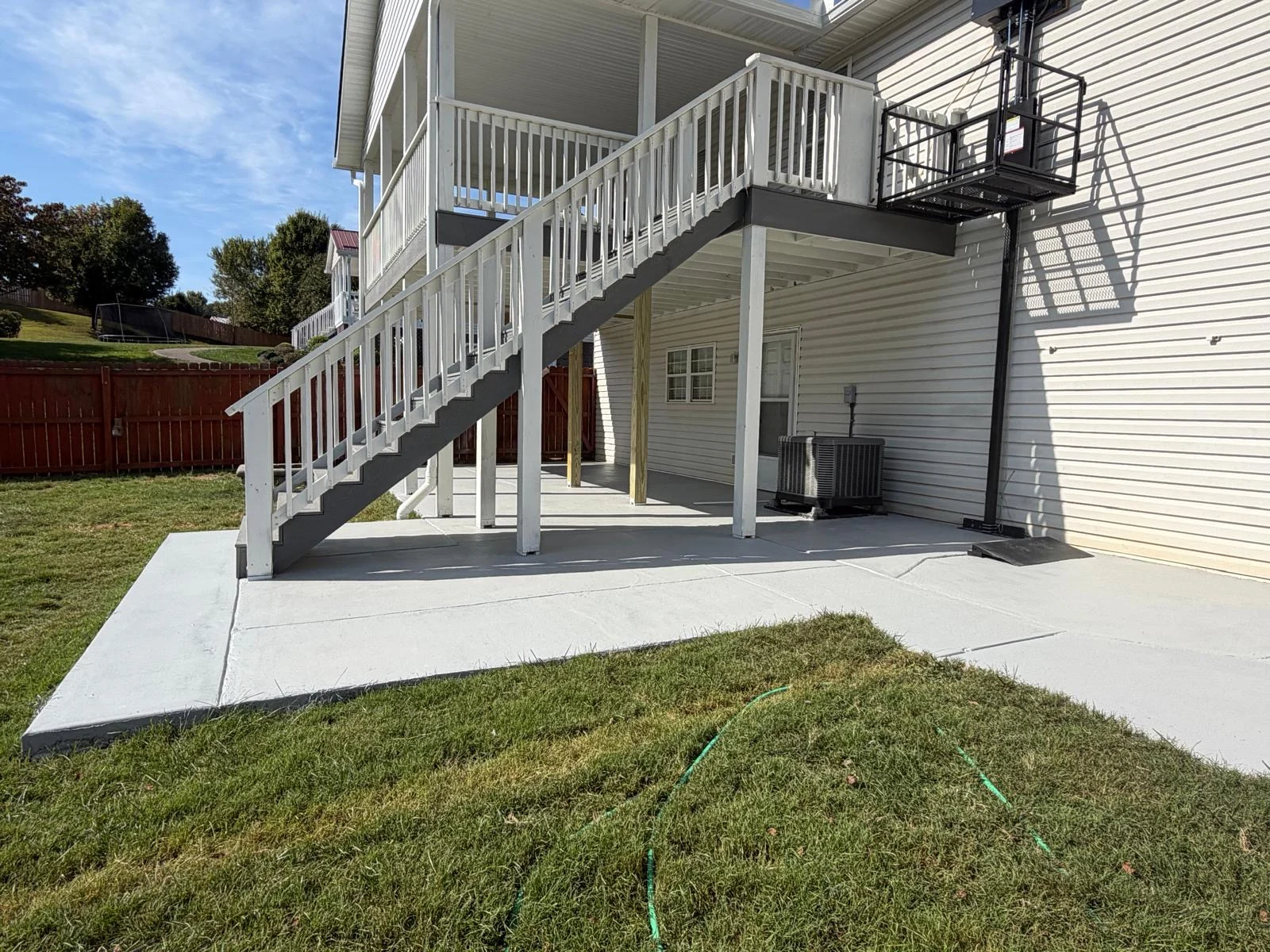 Covered deck with stairs and an exterior platform lift